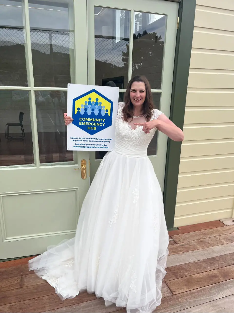 Renee holding up a community emergency hub sign