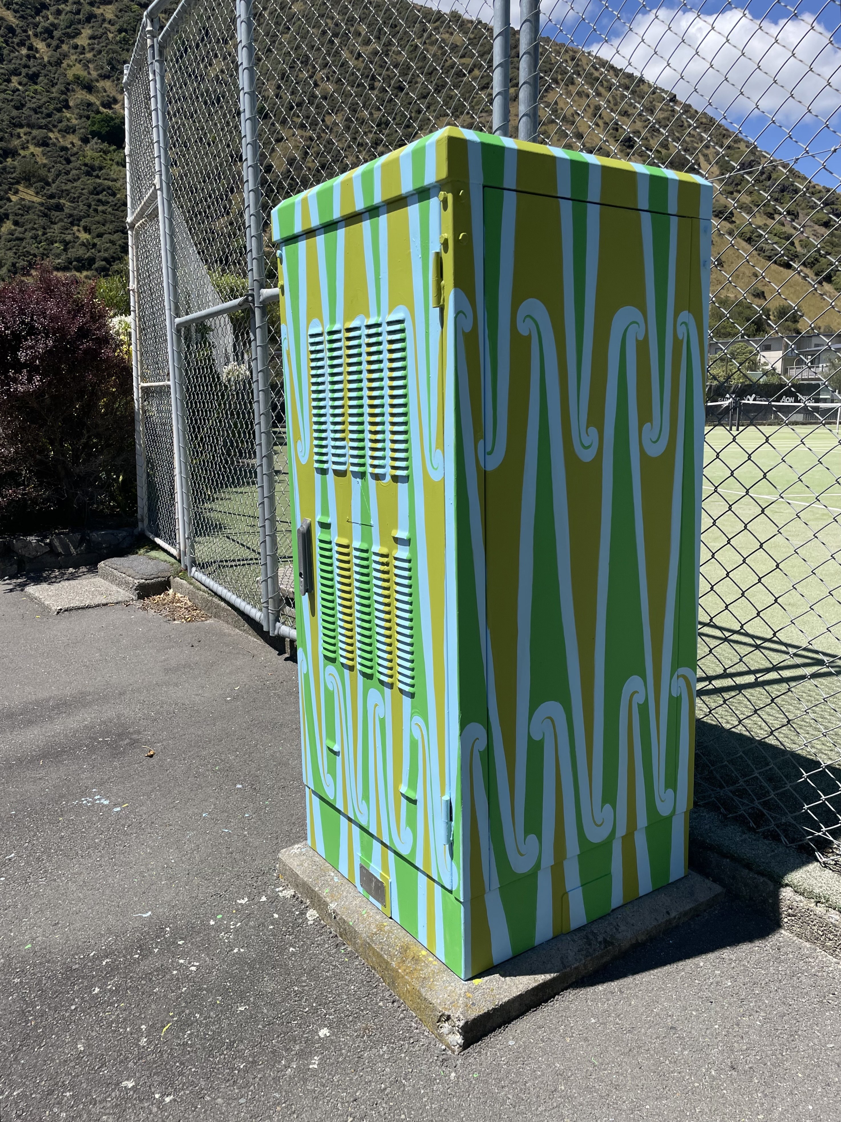 Side and front view of art cabinet 'Pūhoro', painted by Miriama Grace-Smith