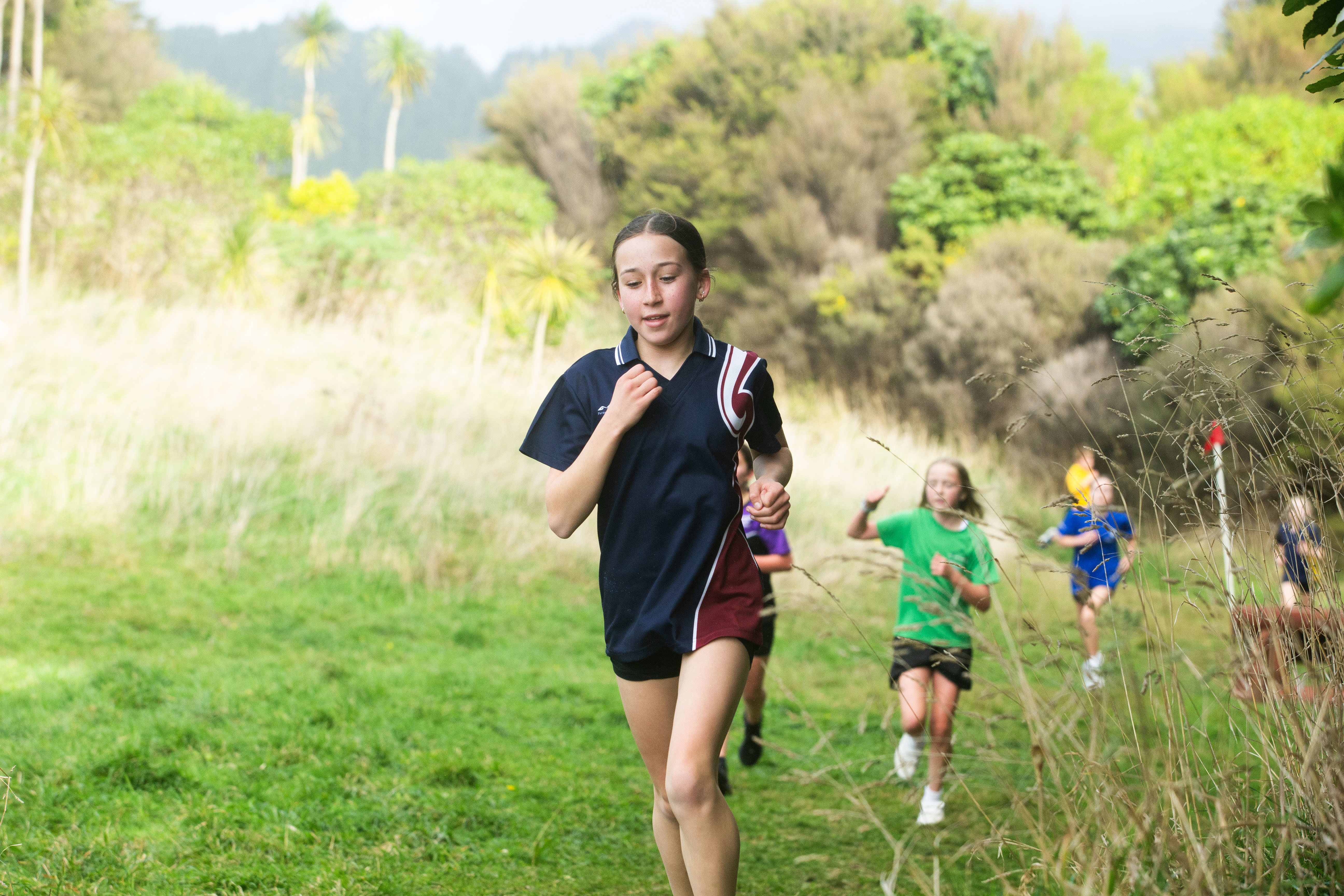 Tamariki running through the bush