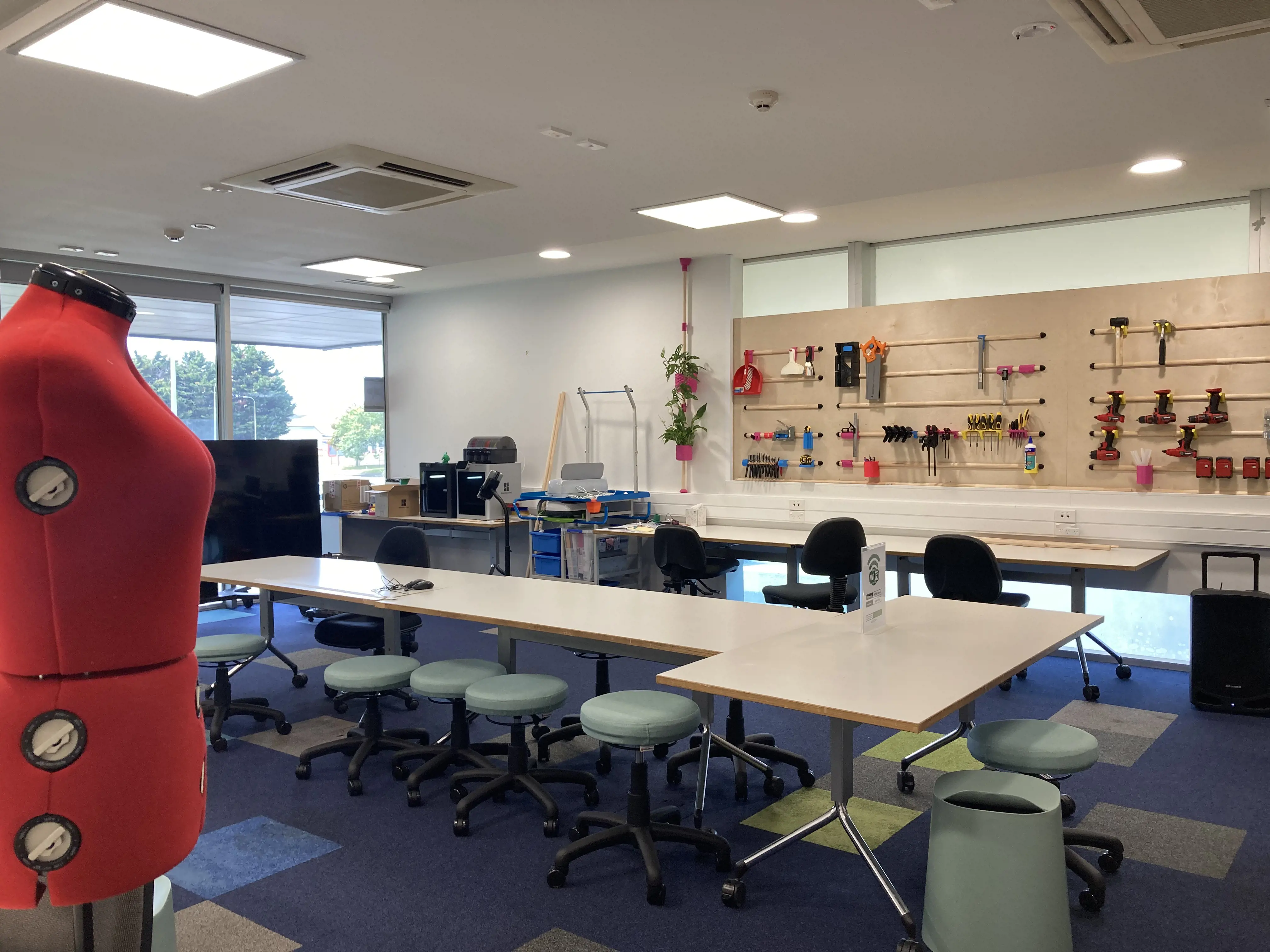 Some of the things you can find at the Makerspace at Paraparumu library, including a sewing mannequin, 3D printer, tools, tables and chairs for working on projects.