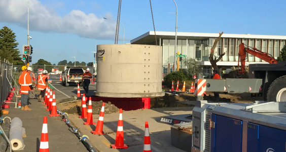 Large stormwater pipe being craned into place outside the Council building on Kāpiti Road.