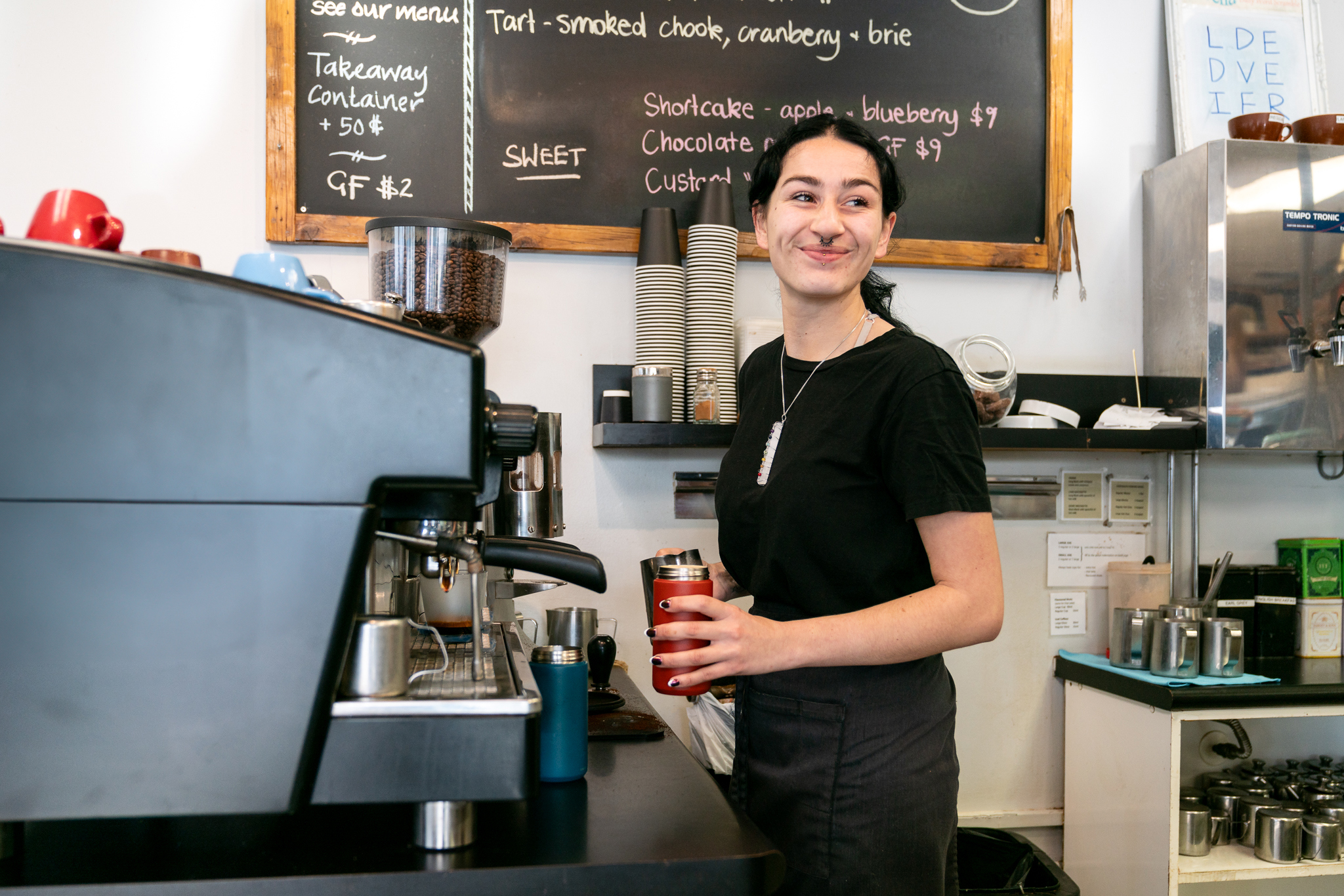 A barista making coffee at a local cafe in Kāpiti