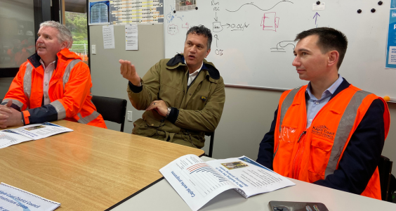 Minister Simeon Brown wears a Kāpiti Coast Council high-vis orange vest speaking with Kāpiti Coast District CEO Darren Edwards at a visit to the Waikanae Water Treatment Plant.