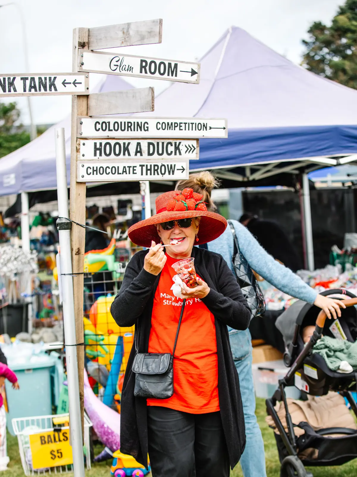 Volunteer enjoying strawberries at the Strawberry Festival
