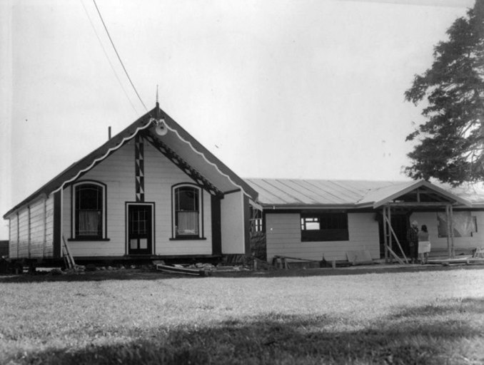 The Whakarongotai meeting house and the dining room under construction in 1979. Pictured are Ani Parata and Pehi Parata. HP 172, Bruce MacMillan Collection, Kāpiti Coast District Libraries.